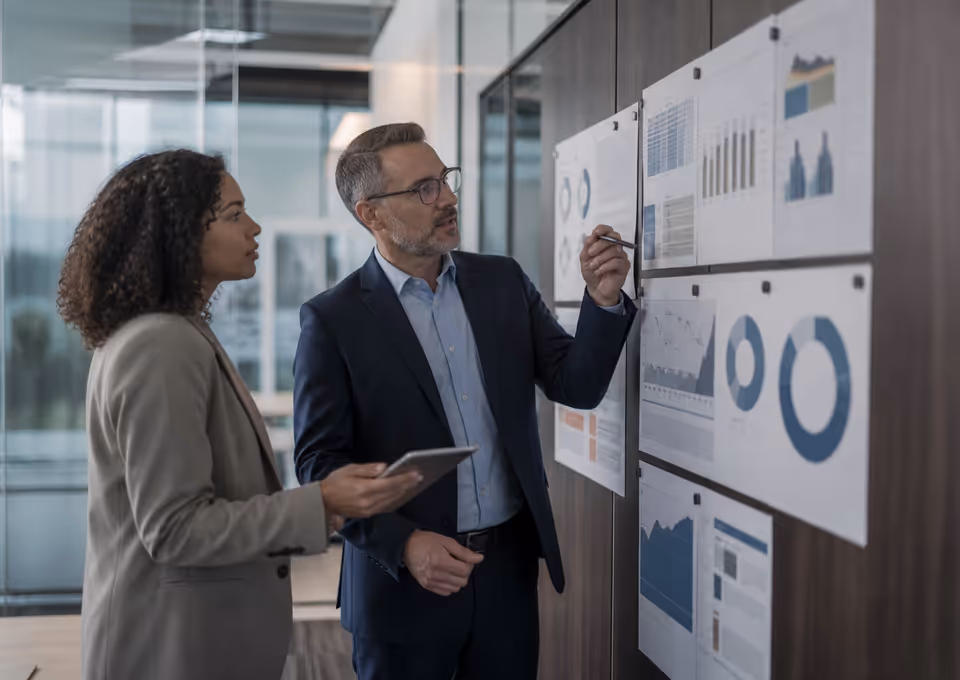 Financial operations leaders reviewing a process board