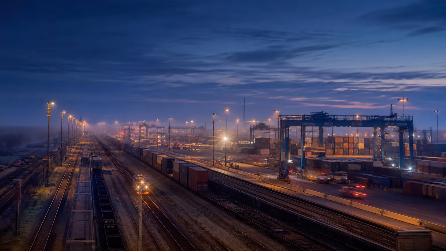 Intermodal rail and logistics routes connected at blue hour