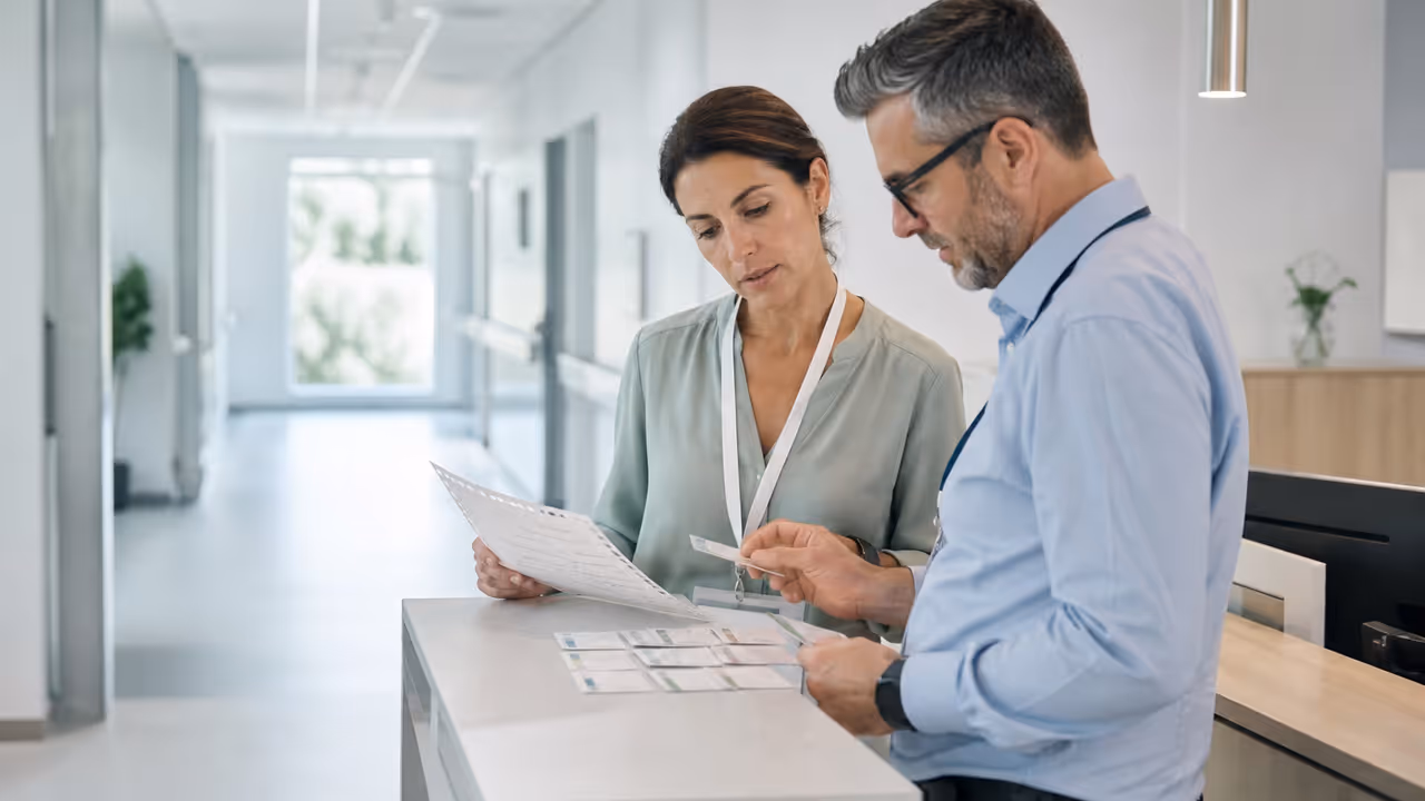Healthcare operations professionals reviewing a handoff checklist
