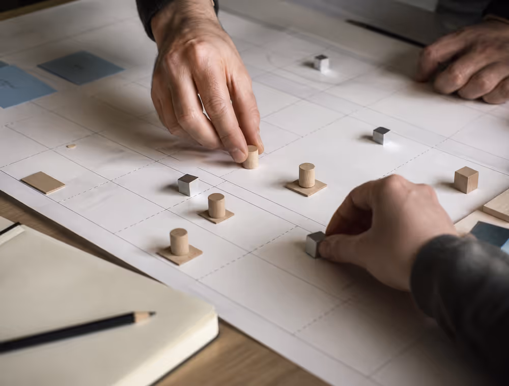 Hands moving markers across a service blueprint